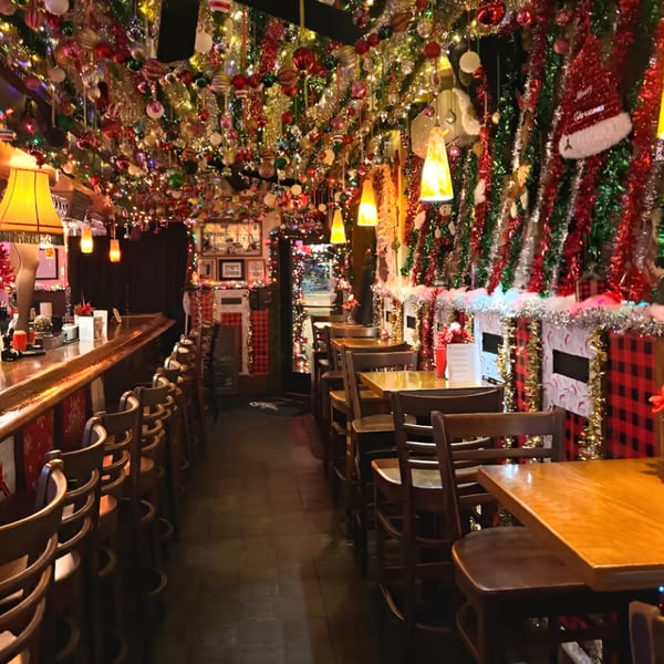 Ale Mary's restaurant interior, heavily decorated with festive Christmas ornaments and lights, featuring a bar and dining tables.