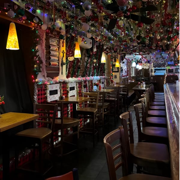 Ale Mary's restaurant interior with festive holiday decorations, tables, and bar seating.