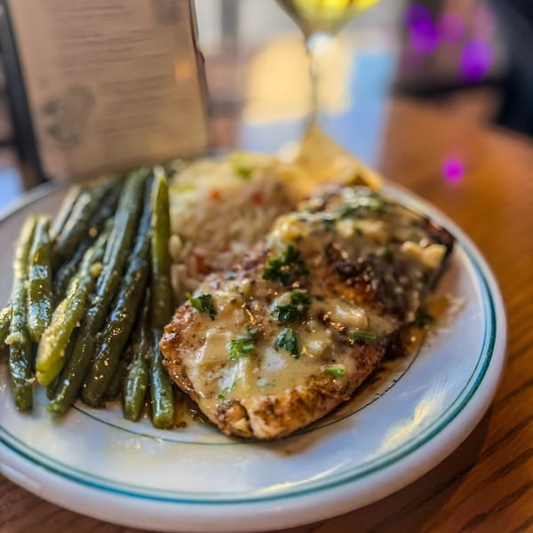 Ale Mary's American dish with chicken, green beans, and rice on a white plate.